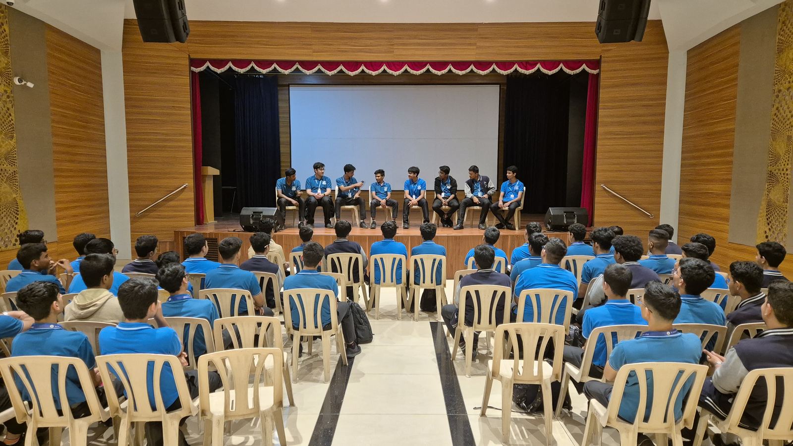 A student panel discussion in a full auditorium