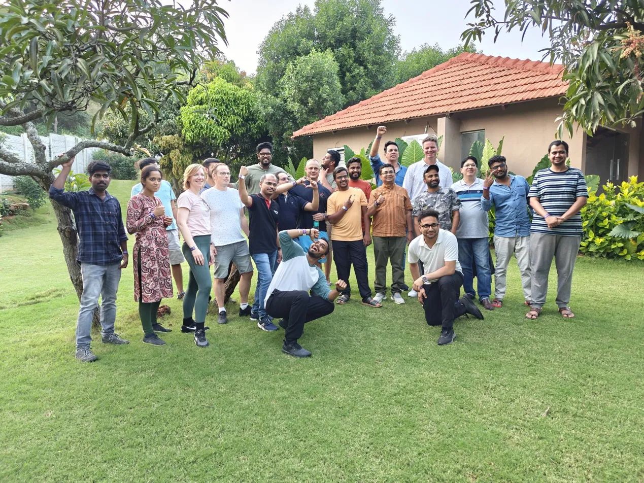 A team posing together outdoors during an offsite